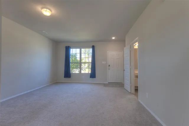 en empty room with windows and closet