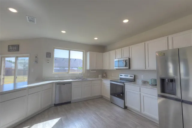 a bathroom with a sink double vanity and a large mirror