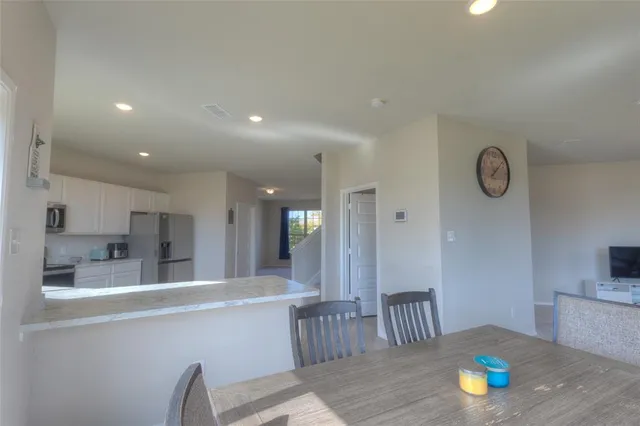 a kitchen with a sink stainless steel appliances and window