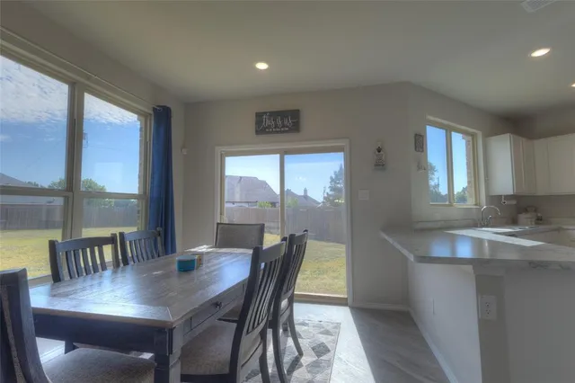 a kitchen with a sink and breakfast area