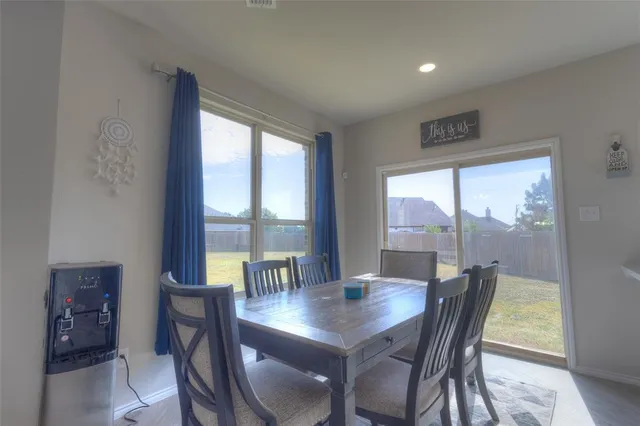 a view of a dining room with furniture and window
