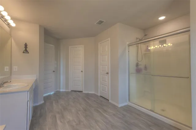 a bathroom with a shower and a sink
