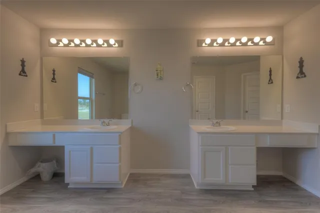 a view of spacious bathroom with a sink and a mirror
