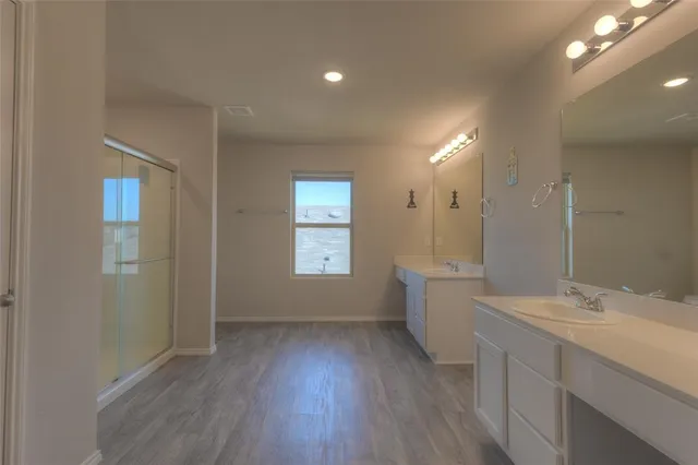 a bathroom with a sink a large mirror and a bathtub