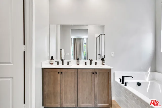 a bathroom with a bathtub sink and mirror