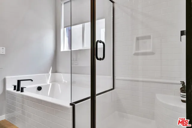 a bathroom with a bathtub and shower