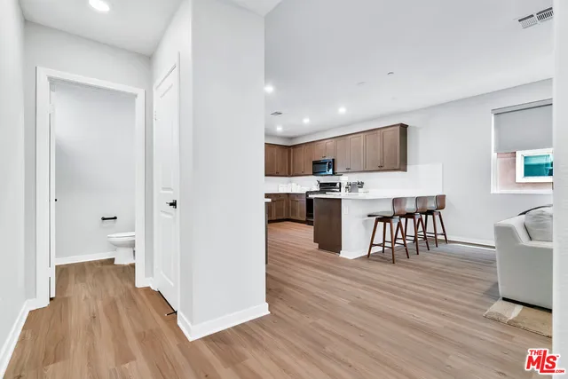 a view of kitchen with cabinets and wooden floor