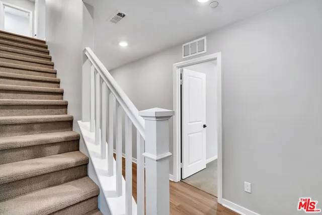 a view of entryway and hall with wooden floor