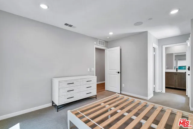 a bedroom with a bed and a dresser