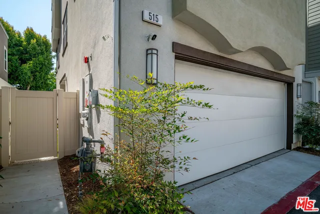 a view of a patio with table and chairs potted plants
