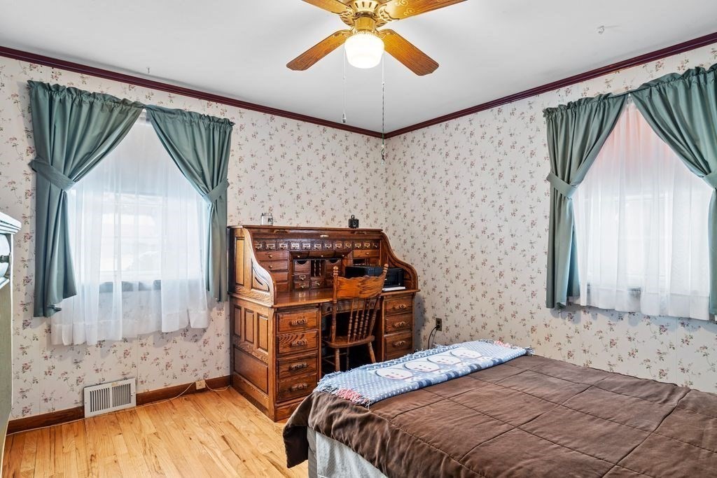 64 Timothy Circle Springfield, MA 01119 - Photo 16 of 34 a bedroom with a bed and a chandelier