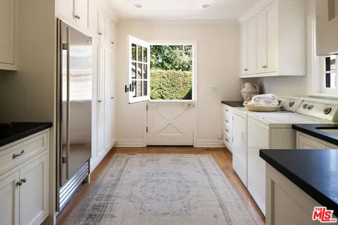 a kitchen with a refrigerator a stove a washer and dryer