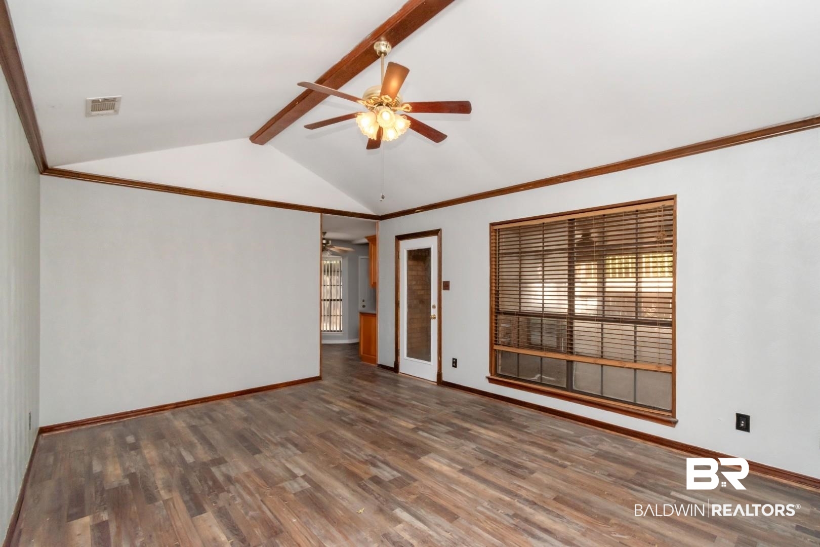 8304 Champlain Circle Mobile, AL 36695 - Photo 22 of 46 Spare room featuring ceiling fan, vaulted ceiling with beams, and dark hardwood / wood-style flooring