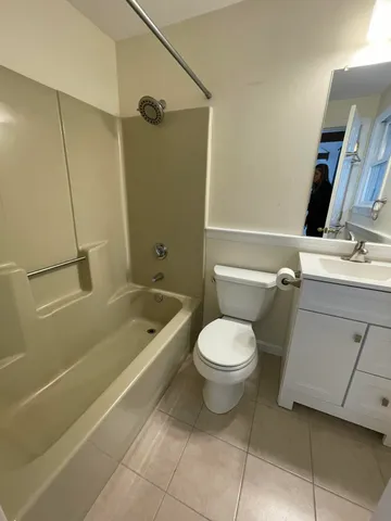 a bathroom with a toilet a sink and bathtub