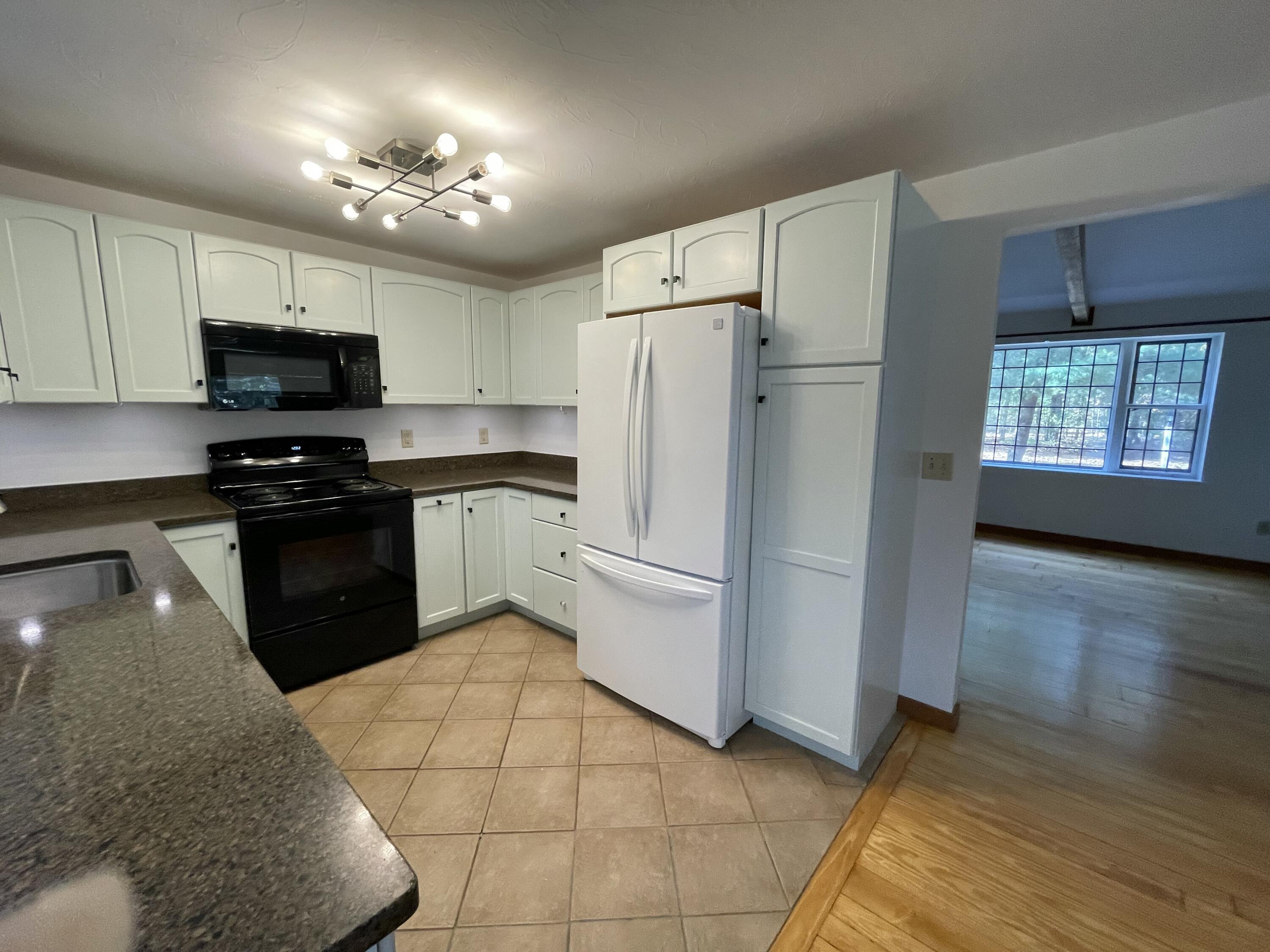 18 Sandy Valley Road Marstons Mills, MA 02648 - Photo 6 of 18 a kitchen with a refrigerator a stove top oven a sink and dishwasher
