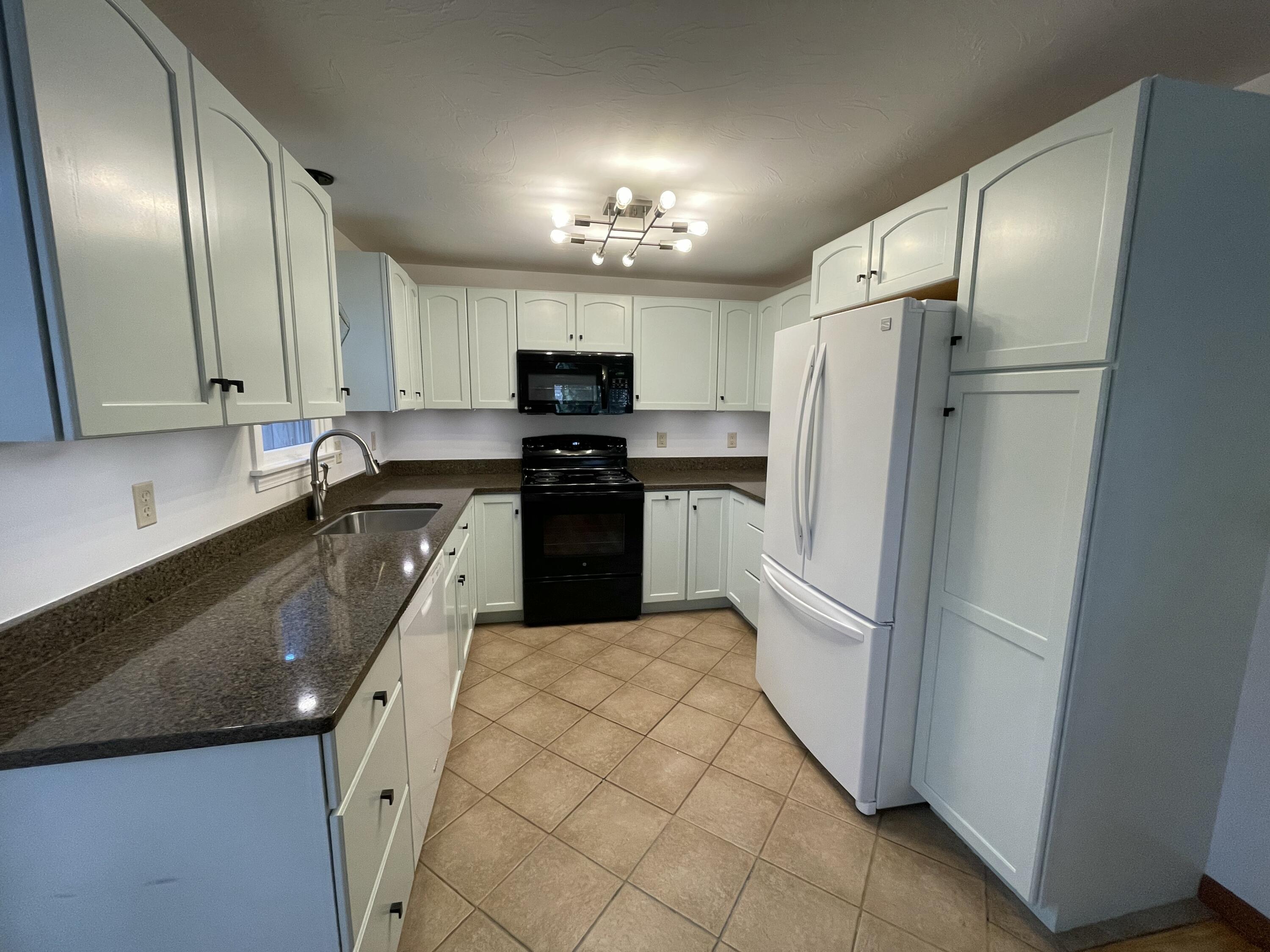 18 Sandy Valley Road Marstons Mills, MA 02648 - Photo 8 of 18 a kitchen with granite countertop a refrigerator a sink a stove and cabinets