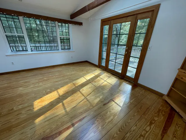 a view of an empty room and a window