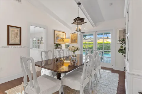 a view of a dining room with furniture wooden floor and chandelier
