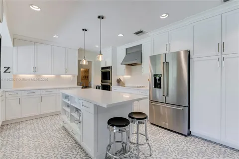 a kitchen with stainless steel appliances a refrigerator stove microwave and cabinets