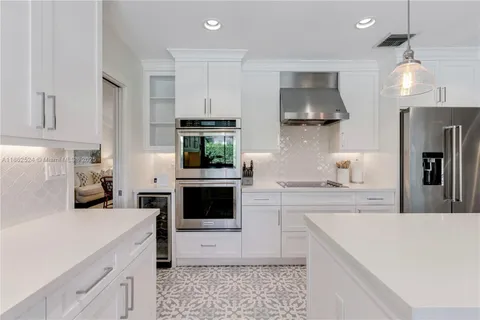 a kitchen with a sink a stove and cabinets