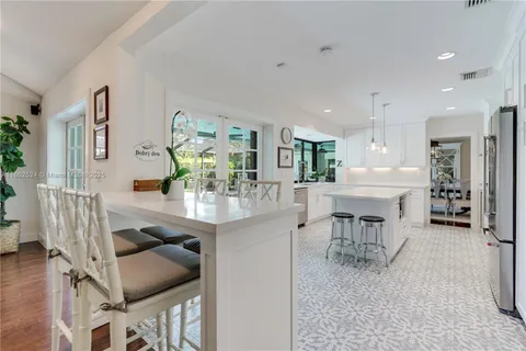 a living room with furniture and a dining table with kitchen view