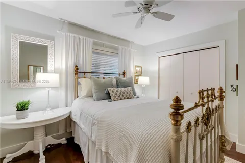 a living room with furniture and view of wooden floor