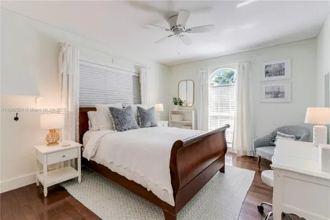 a view of a patio with a table and chairs under an umbrella