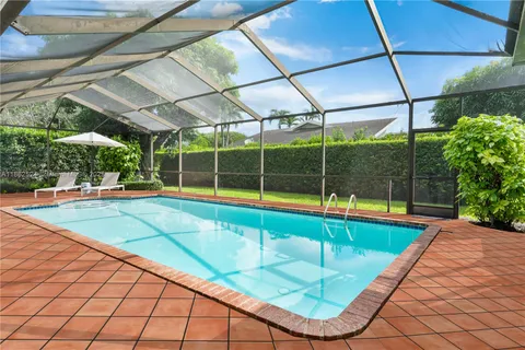 an aerial view of a house with swimming pool and garden