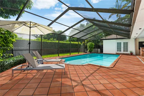 an aerial view of a house with a swimming pool