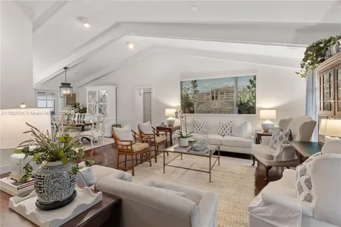 a living room with furniture potted plant and a mirror