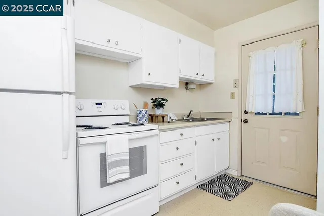 a bedroom with a bed chandelier and window