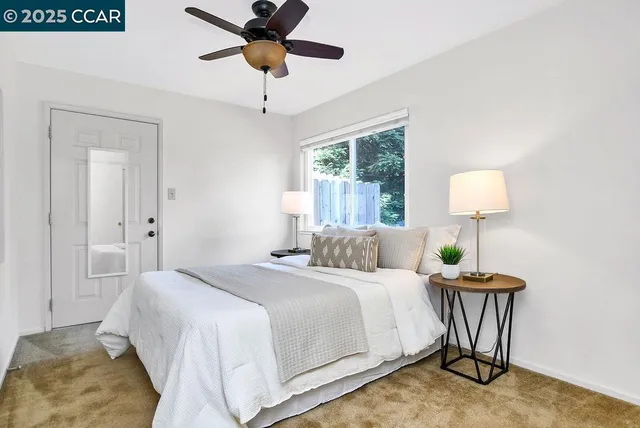 a bedroom with a bed and a lamp