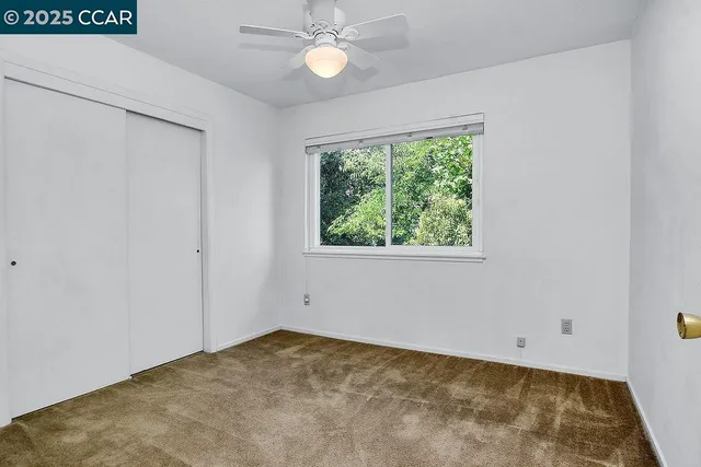 an empty room with a ceiling fan
