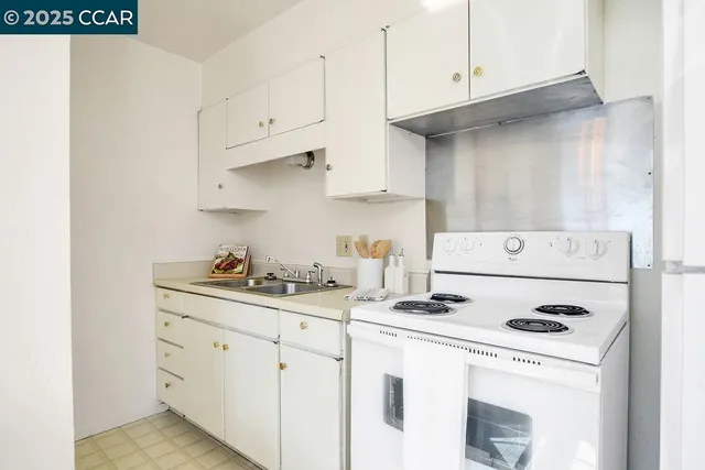 a kitchen with cabinets appliances a sink and a stove