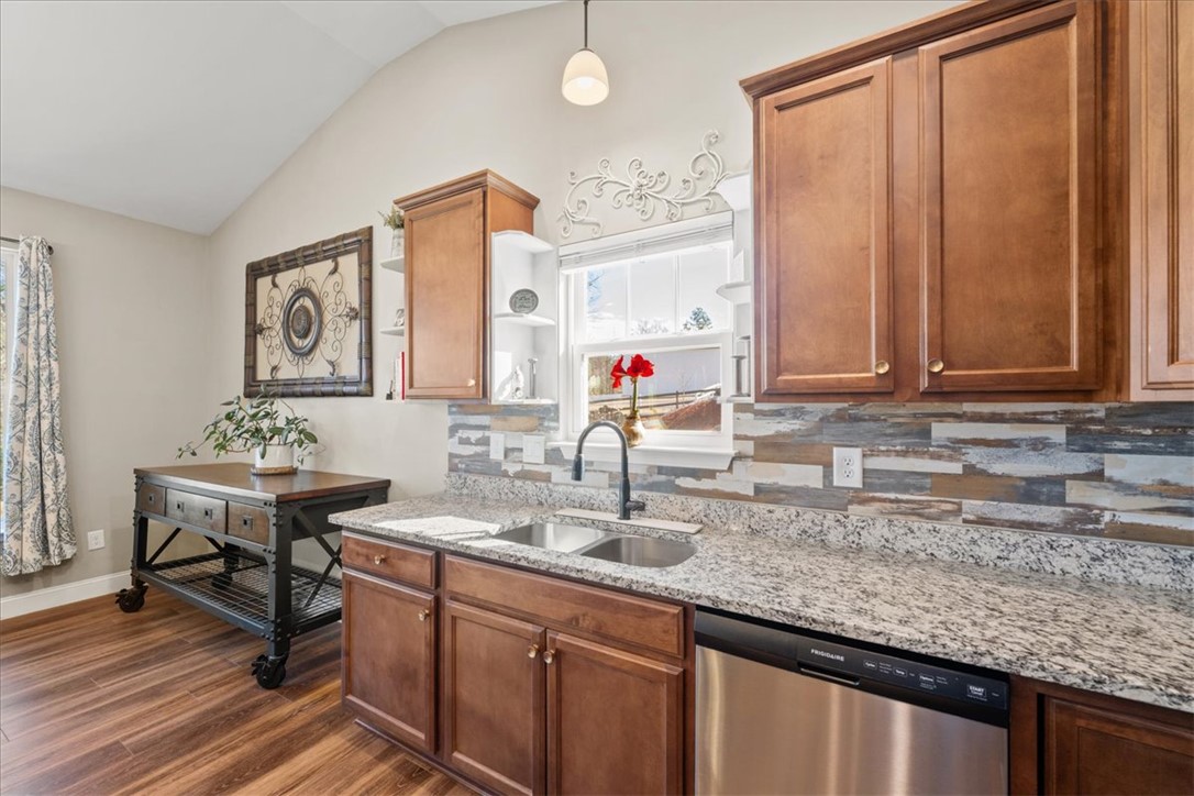 104 Inlet Pointe Drive Anderson, SC 29625 - Photo 13 of 50 This bright kitchen features vaulted ceilings and modern appliances, creating a welcoming and functional space.