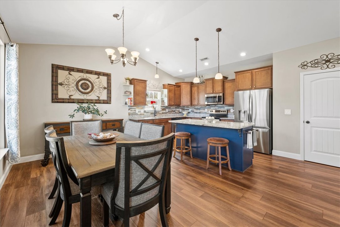 104 Inlet Pointe Drive Anderson, SC 29625 - Photo 17 of 50 This open concept kitchen and dining area features vaulted ceilings and rich wood flooring.