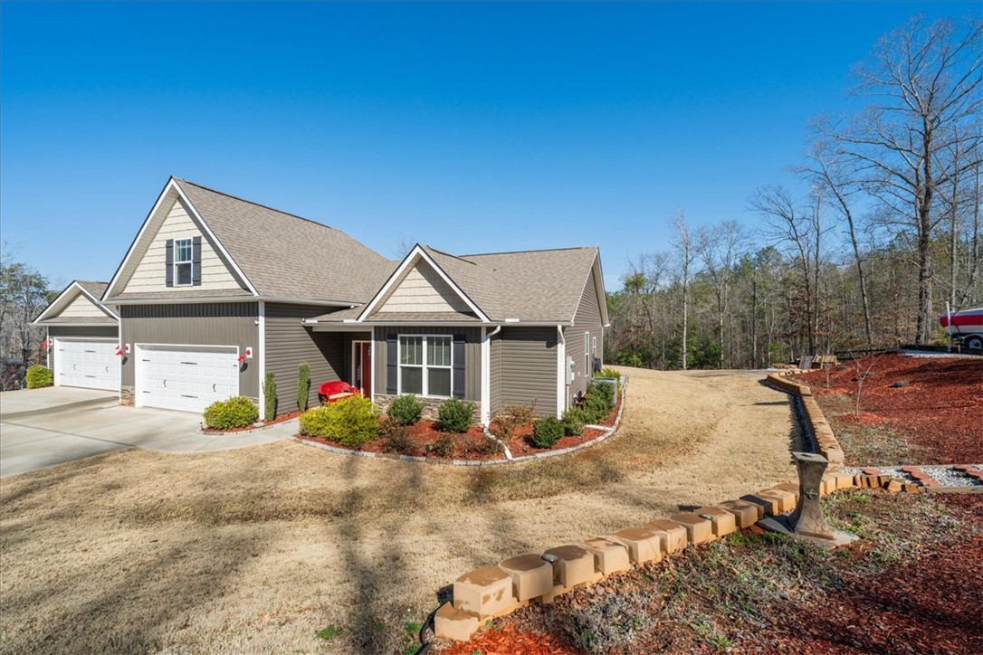 104 Inlet Pointe Drive Anderson, SC 29625 - Photo 2 of 50 This charming home offers a two-car garage and a well-maintained lawn.
