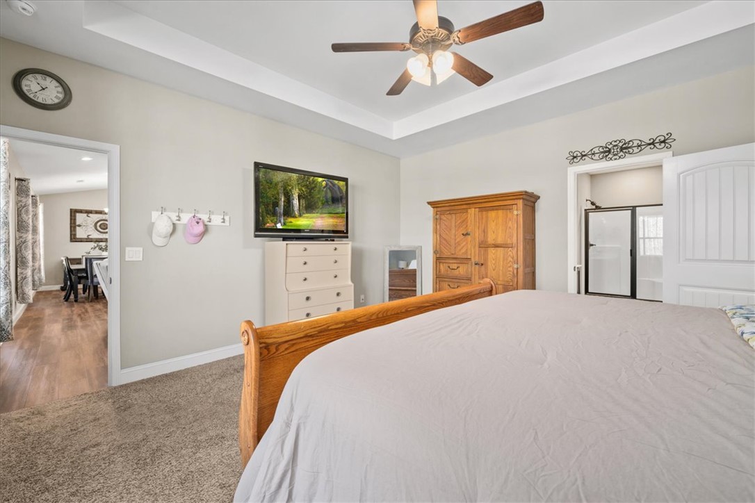 104 Inlet Pointe Drive Anderson, SC 29625 - Photo 20 of 50 This spacious bedroom features a ceiling fan and elegant tray ceiling for comfort and style.