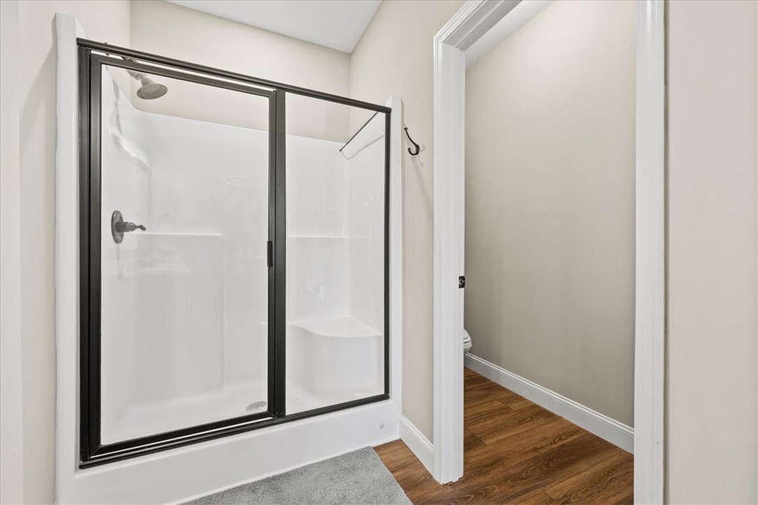 104 Inlet Pointe Drive Anderson, SC 29625 - Photo 22 of 50 This bathroom features a contemporary shower with sleek glass doors and rich wood flooring.