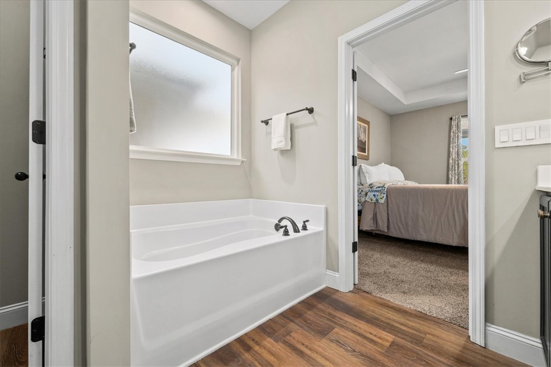 104 Inlet Pointe Drive Anderson, SC 29625 - Photo 23 of 50 This spacious bathroom offers a relaxing soaking tub and convenient access to an adjacent bedroom.