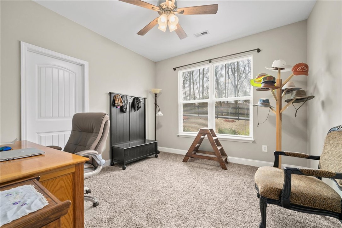 104 Inlet Pointe Drive Anderson, SC 29625 - Photo 25 of 50 This versatile room features ample natural light and plush carpeting, ideal for a home office or creative space.