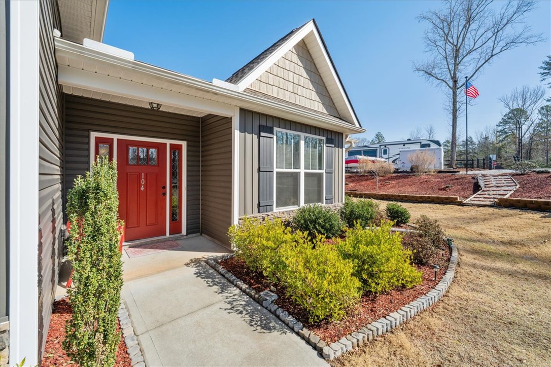 104 Inlet Pointe Drive Anderson, SC 29625 - Photo 3 of 50 This charming home offers a welcoming entrance with manicured landscaping and clear skies.