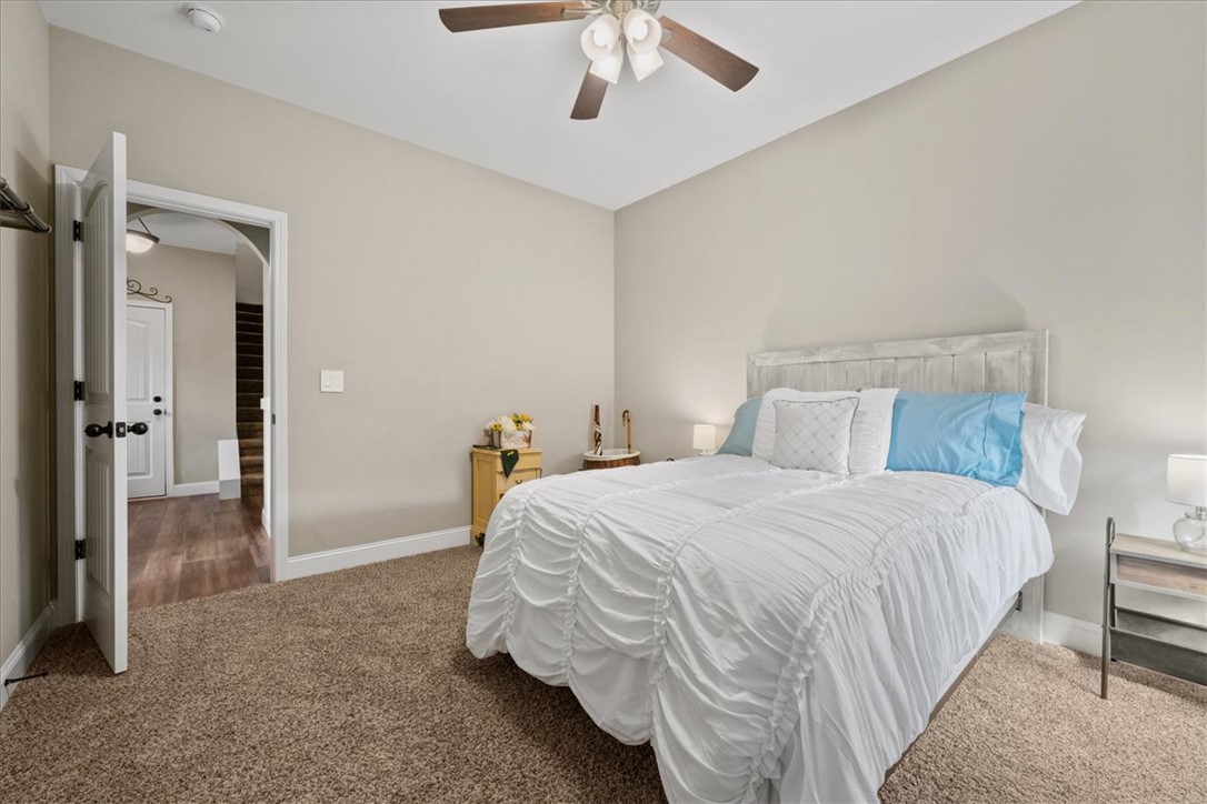 104 Inlet Pointe Drive Anderson, SC 29625 - Photo 30 of 50 This cozy bedroom offers a tranquil retreat with soft carpet and a classic ceiling fan.