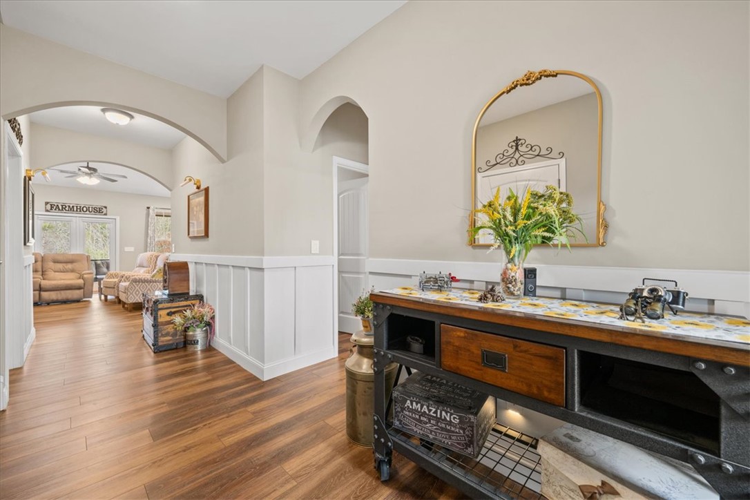 104 Inlet Pointe Drive Anderson, SC 29625 - Photo 7 of 50 This inviting hallway features warm wood flooring and classic wainscoting.