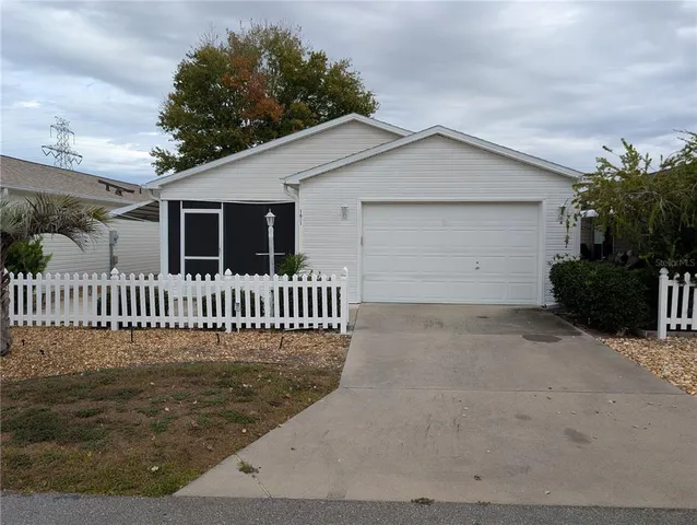 a view of a house with a yard and garage