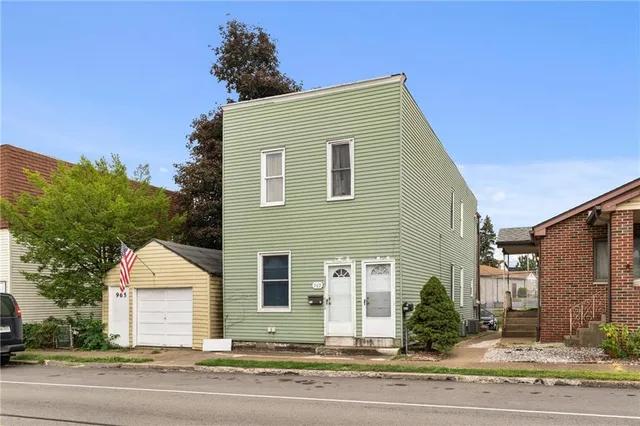 a view of a house with a yard and garage