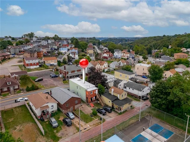 an aerial view of residential houses with outdoor space