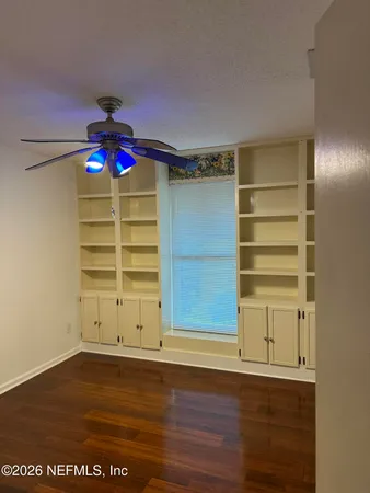 an empty room with cabinet and entryway