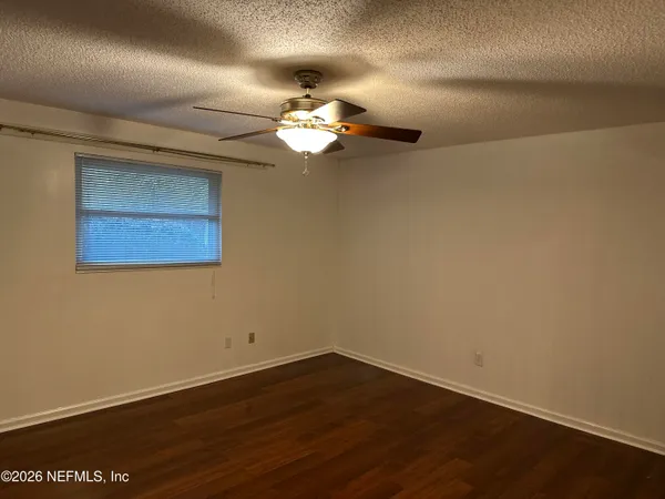 a view of a room with wooden floor