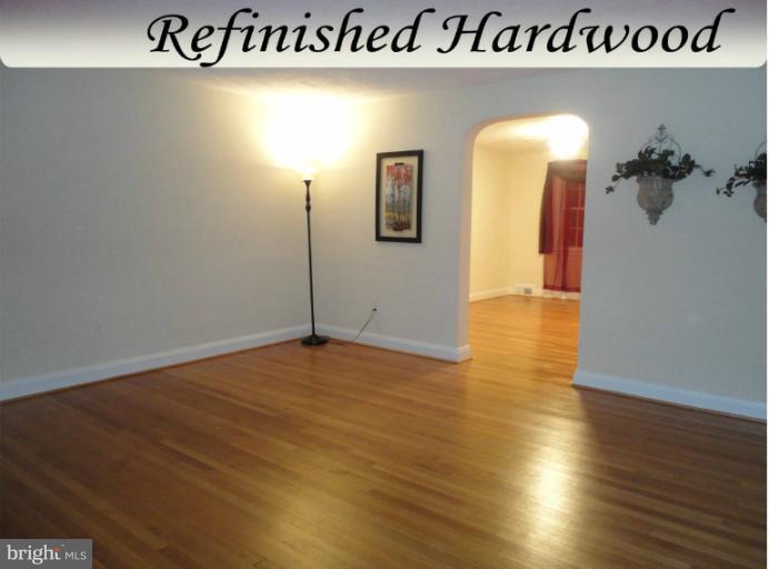 4930 Lindsay Road Baltimore, MD 21229 - Photo 6 of 25 a view of a room with wooden floor and mirror